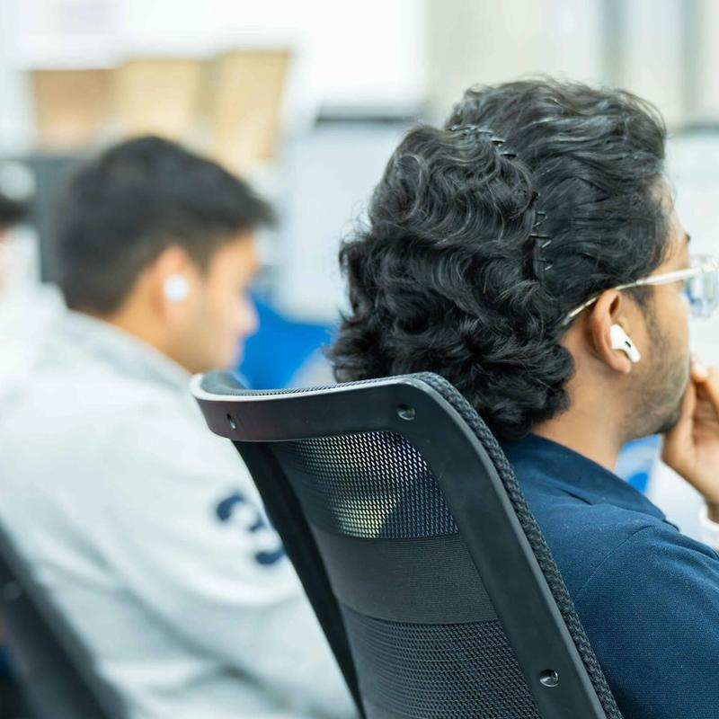 A row of C5 Team Members working at their desks in the C5 office