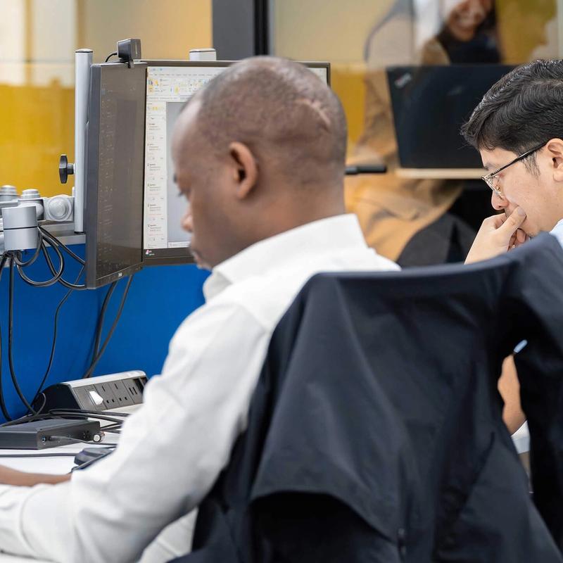 A pair of C5 Team Members working at their desks in the C5 office
