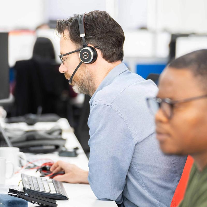 Two C5 Team Members working on at their desks in the C5 office