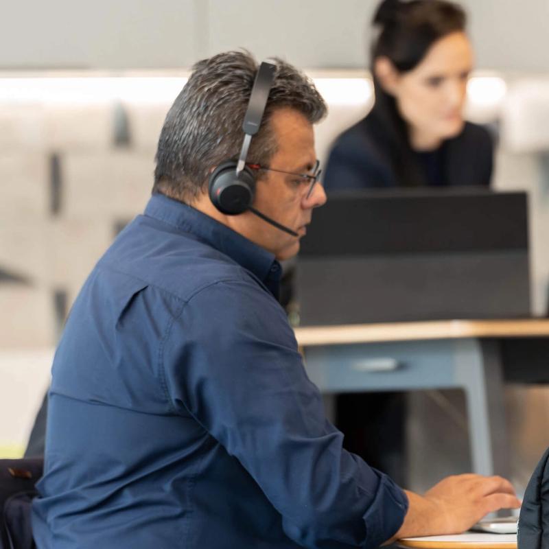 People working remotely in the C5 hub on their laptops and tablets