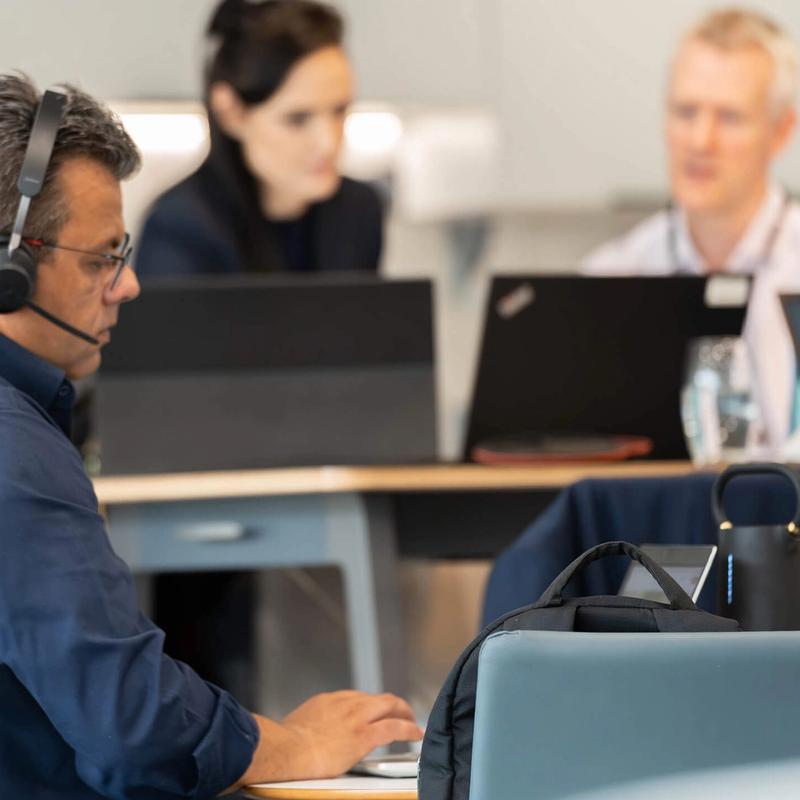 People working remotely in the C5 hub on their laptops and tablets