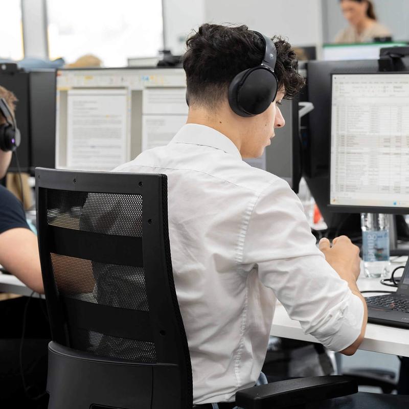 A row of C5 Team Members working at their desks in the C5 office