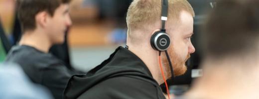 A row of C5 IT Services Team Members working at their desks in the C5 office